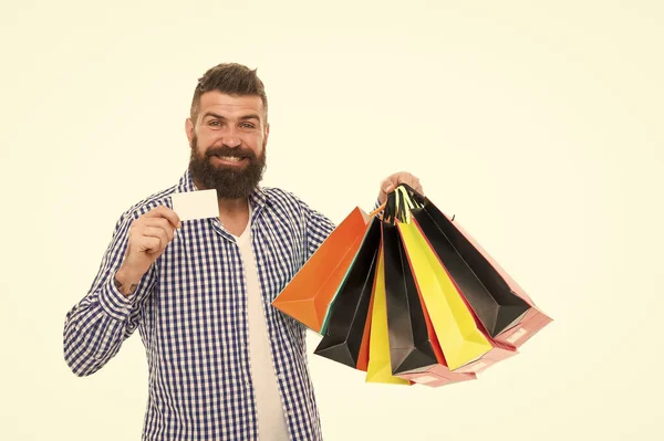 Hes got a loyalty card. Bearded man smiling with discount card and paperbags isolated on white. Happy businessman showing blank card for business information. Paying with credit card, copy space — Stock Photo, Image