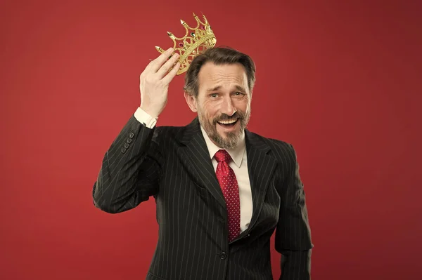 Winner at life. Successful prize winner putting crown jewel on head on red background. Best company award winner. Being a big winner