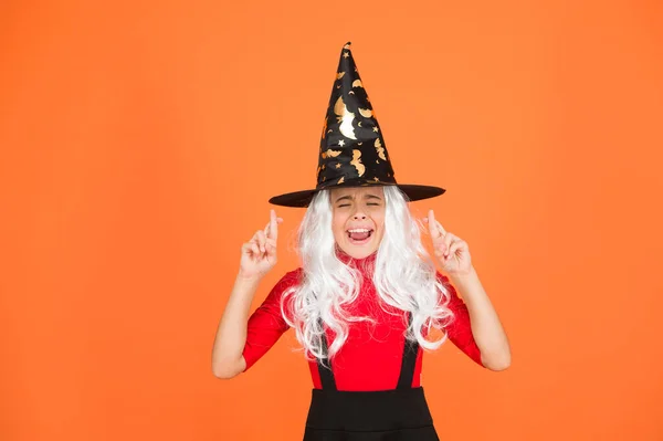 Hope spell works. Little child in witch costume. Halloween party. Small girl in black witch hat. Autumn holiday. Join celebration. Magical spell. Small witch with white hair. Wizard or magician