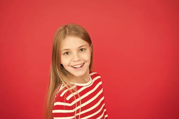 Good parenting. Child care. family and love. childrens day. happy little girl on red background. small girl child. School education. Childhood happiness. copy space. Little daydreamer — Stock Photo, Image