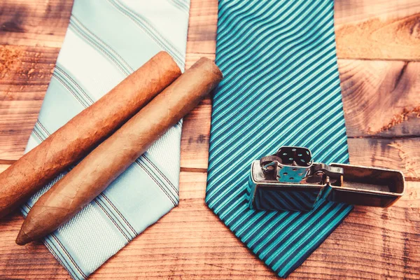 necktie for real men. Modern formal style. male tie and cigar. Male shop. vintage. retro style. Cigar and lighter. Wedding elegant accessory. Fashion look. Business detail. mens club