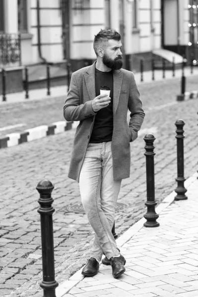 Takeaway coffee. Walk and enjoy fresh hot coffee. Waiting for someone in street. Man bearded hipster drink coffee paper cup. Businessman well groomed enjoy coffee break outdoors urban background — Stock Photo, Image
