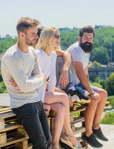Having fun. best friends. Summer vacation. diverse young people talking together. group of four people. The great fit for the day off. Group of people in casual wear. cheerful men and girl relax