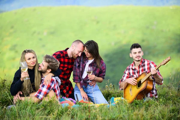 Carefree camping. hiking adventure. happy men and girls friends with guitar. friendship. romantic picnic in tourism camp. campfire songs. group of people spend free time together. family camping — Stock Photo, Image