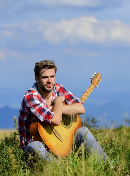 Music is my life. country music song. cowboy man with acoustic guitar player. sexy man with guitar in checkered shirt. hipster fashion. happy and free. western camping and hiking