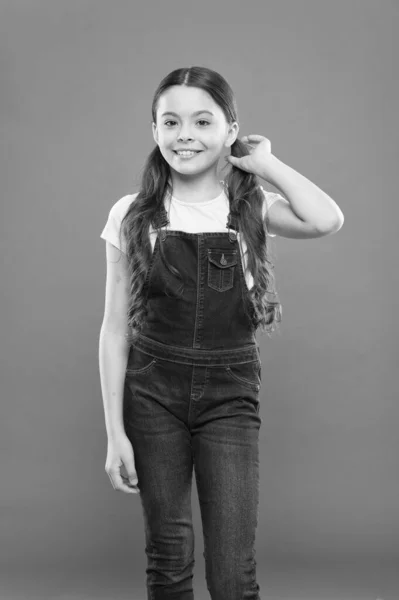 I am kind of a hipster. Happy little hipster on orange background. Cute small hipster smiling with fashionable look. Adorable girl child wearing hipster style outfit — Stock Photo, Image