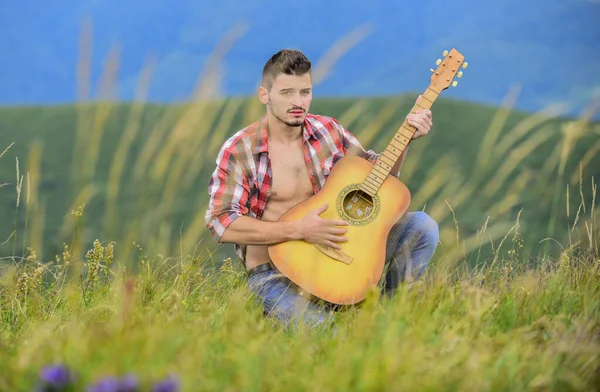 Acoustic music. Summer music festival outdoors. Playing music. Sound of freedom. Inspired musician play rock ballad. Compose melody. Inspiring environment. Man with guitar on top of mountain