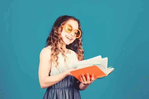 Hobby and leisure. Top funny books to read. Beach reads for summer. Kid likes reading book. Popular vacation books. Great books for summer vacation. Girl in sunglasses hold book. Summertime concept