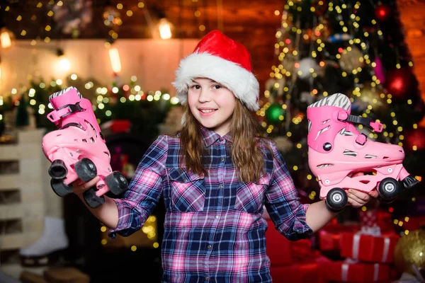 Got gift exactly she wanted. Kid near christmas tree hold roller skates. Girl satisfied christmas gift. Christmas gift she dreamed about. Best gift ever. Happy new year concept. Dreams come true