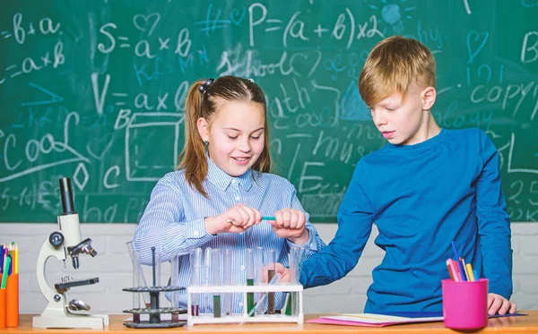 Análisis químico. Los niños estudian química. Lección de química escolar. Laboratorio escolar. Educación escolar. Chica y niño se comunican mientras realizan el experimento escolar. Niños estudiando juntos en clase — Foto de Stock