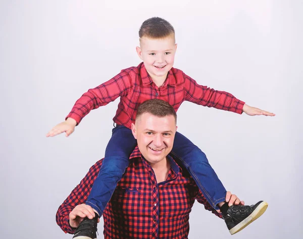 Having fun. Fathers day. Father example of noble human. Family time. Best friends. Father little son red shirts family look outfit. Child riding on dads shoulders. Happiness being father of boy