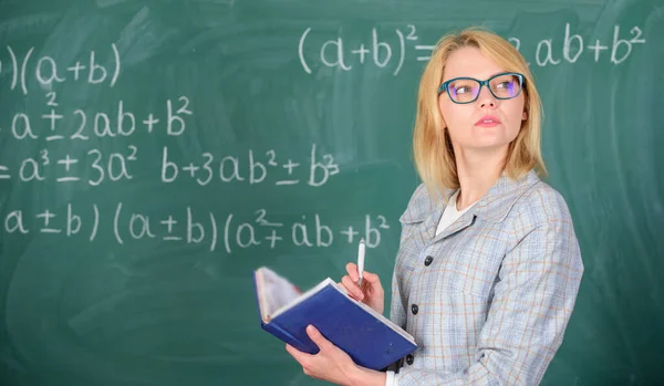 Woman teaching near chalkboard in classroom. Effective teaching involve acquiring relevant knowledge about students. Qualities that make good teacher. Principles can make teaching effective — Stock Photo, Image