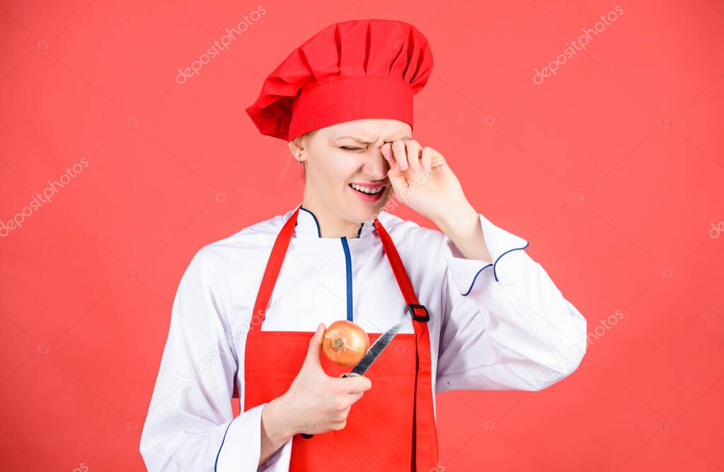Kitchen routine. Girl cooking healthy meal. Housewife cook crying while cutting onion. Slice and chop onion. Suffer but keep doing. Stinging eyes and tears cutting onions. Chef cook peeling onion