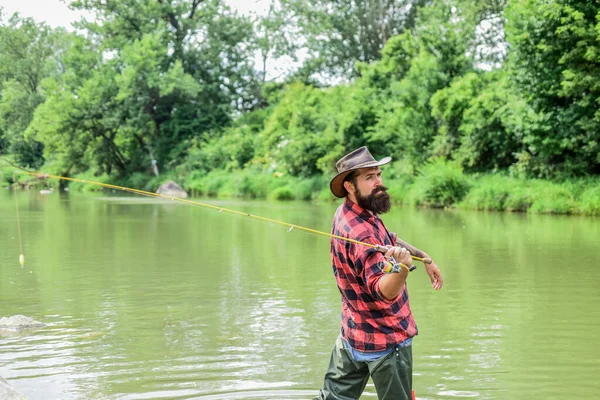 Born to Fish. hobby and sport activity. pothunter. bearded fisher in water. mature man fly fishing. man catching fish. summer weekend. Big game fishing. fisherman with fishing rod — Stock Photo, Image