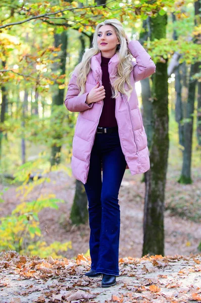 How to rock puffer jacket like a star. Puffer fashion concept. Woman wear warm pink jacket. Girl fashionable blonde walk in autumn forest. Jackets everyone should have. Best puffer coats to buy