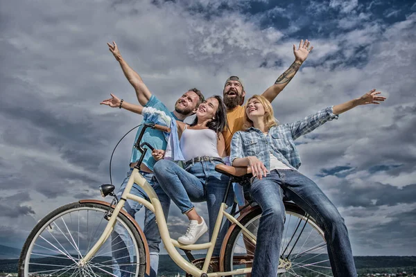 Freedom urban commuting. Bicycle as part of life. Company stylish young people spend leisure outdoors sky background. Cycling modernity and national culture. Group friends hang out with bicycle