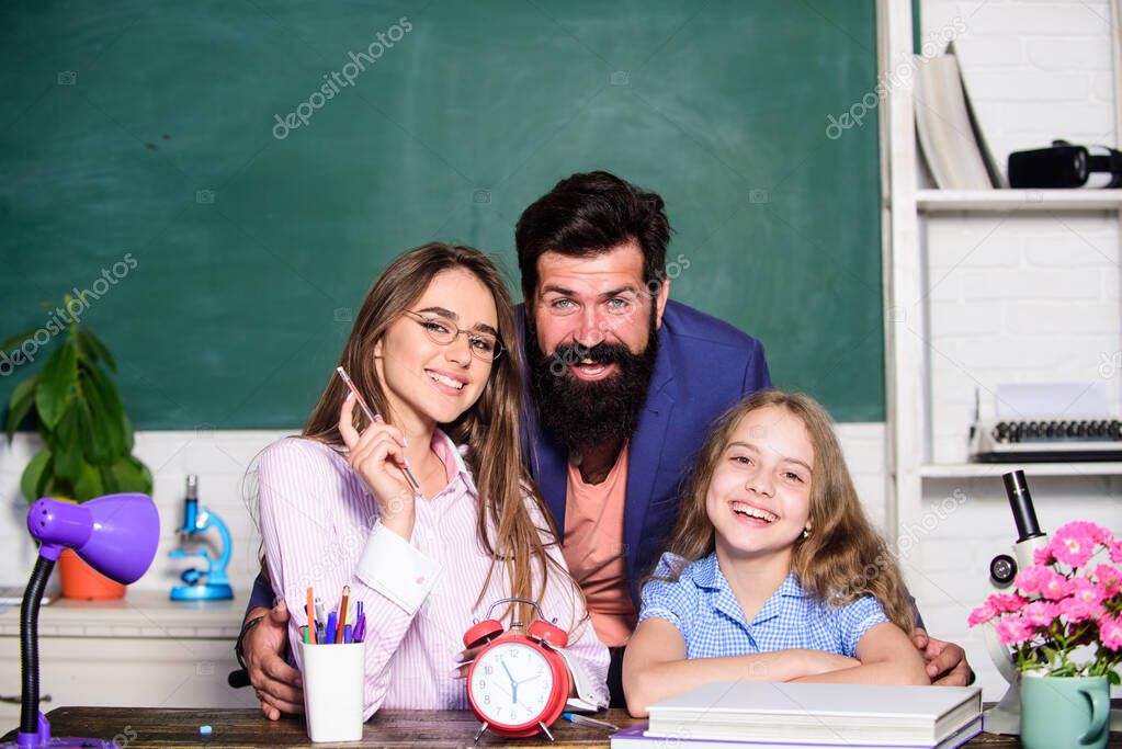 Happy lesson. Happy family have school lesson. Little child and parents during lesson time. Private lesson. Home schooling