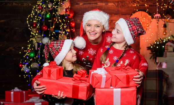 Little girls with lot gift boxes. Christmas morning routine for moms. Mom hug daughters near christmas tree. Happy family concept. Wonderful moments christmas. Achieve impeccable christmas day
