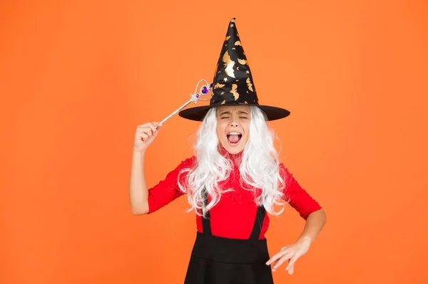Magical spell. Little child in witch costume. Halloween party. Small girl in black witch hat. Autumn holiday. Join celebration. Magical spell. Small witch with white hair. Wizard with magic stick — Stock Photo, Image
