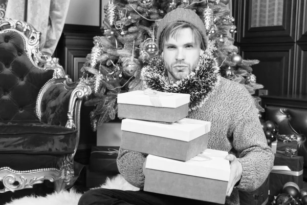 Ο τύπος με κουτιά δώρων καθίσει στο χριστουγεννιάτικο δέντρο — Φωτογραφία Αρχείου