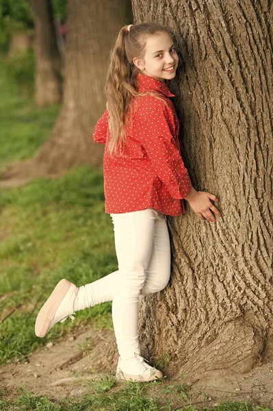 Girl little cute child enjoy peace and tranquility at tree trunk. Calm and peaceful. Life balance. Peaceful mood. Good vibes only. Place of power. Peaceful place. Find peace and relax in nature