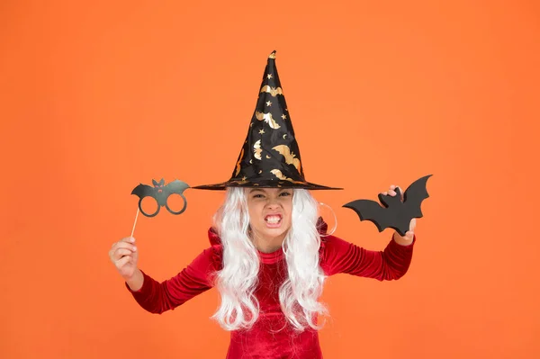 Photo booth props. Small girl in black witch hat. Autumn holiday. Join celebration. Little child in witch costume. Magical spell. Small witch with white hair. Wizard or magician. Halloween party — Stock Photo, Image