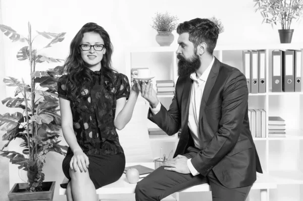 Man and woman conversation coffee time. Office rumors. Office coffee. Couple coworkers relax coffee break. Share coffee with with colleague. Flirting colleagues. Bearded man and attractive woman — Stock Photo, Image