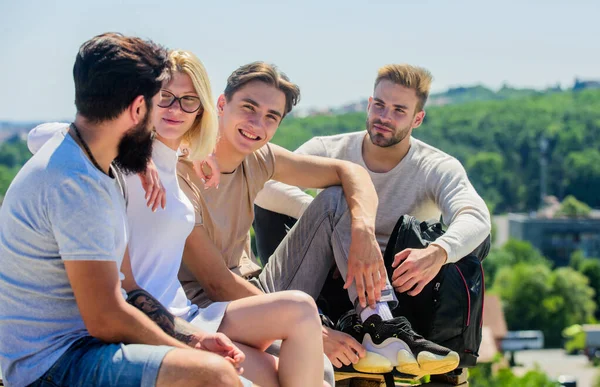 Having fun together. group of four people. great fit for day off. best friends. Summer vacation. happy men and girl relax. Group of people in casual wear. diverse young people talking together