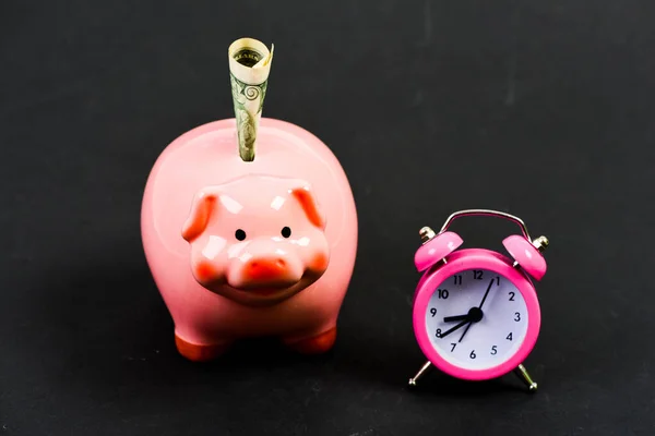 Piggy bank stuffed dollar cash and alarm clock. Financial crisis. Banking account. Bankruptcy and debt. Pay for debt. Bank collector service. Credit debt. Economics and finance. It is time to pay