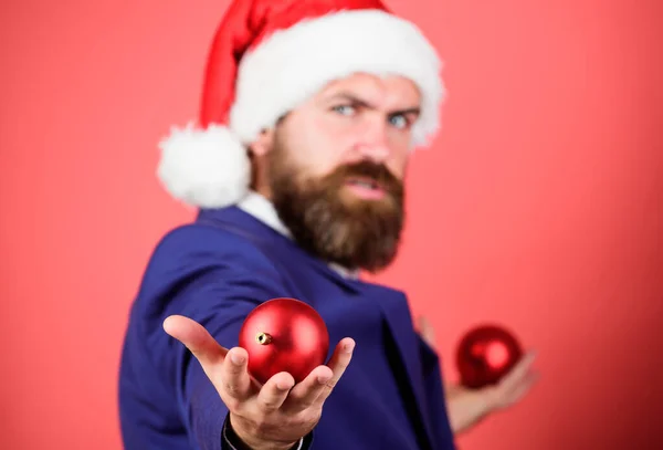 Giving is better than receiving. Man with beard hold red balls christmas decorations selective focus. Winter holidays. Christmas mood. Spread magic christmas atmosphere. Radiate christmas generosity