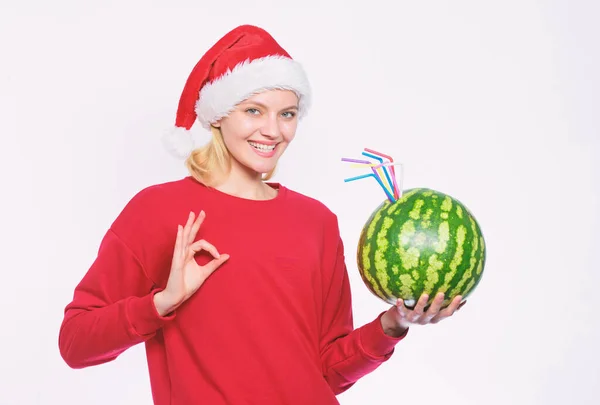 Woman enjoy vitamin drink. Rich vitamin ration concept. Winter vitamin fruit ration. Detox after christmas. Strengthen immunity concept. Girl wear santa hat drink watermelon vitamin cocktail straw