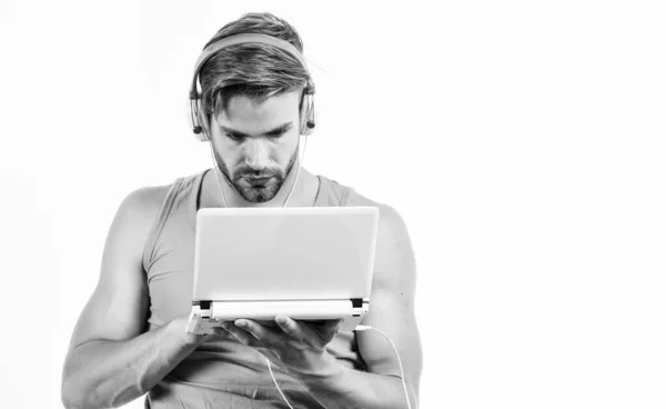 Free online music sources. cyber monday concept. sexy muscular man listen audio. man in earphones isolated on white. e book. unshaven man listening audio book