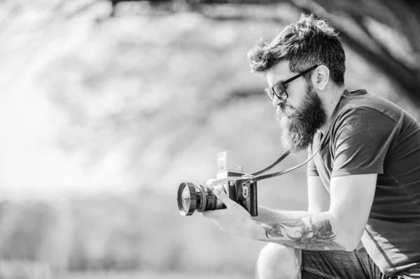 Smile. retro photographic equipment. brutal photographer with camera. photo of nature. reporter or journalist. hipster man in summer sunglasses. Mature hipster with beard. Bearded man. copy space