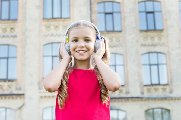Devoted to beautiful music. Happy kid listen to music outdoor. Adorable small child enjoy music playing in earphones. Her favorite music. Leisure and pleasure. Fun. Relax — Stock Photo, Image