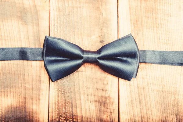 Fashion accessory. male bow tie on wood. Esthete detail. Modern formal style. vintage and retro style. Groom wedding. Wedding accessories. Elegant look. illusionist
