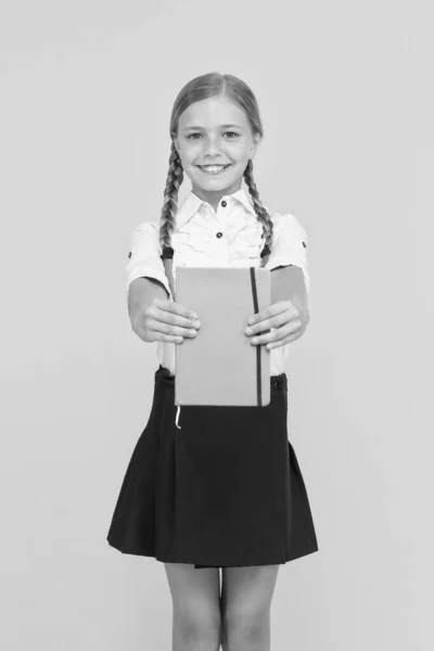 School club after classes. Study foreign language. Essay for homework. KId girl student likes to study. Study literature. Private lesson. Adorable child schoolgirl hold copybook. Formal education