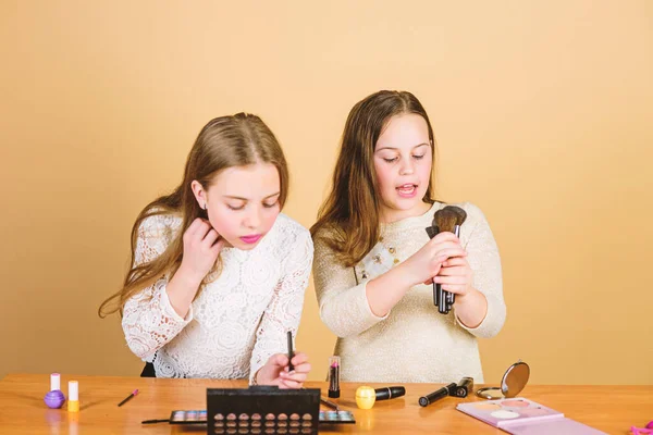 Makeup store. Experimenting with style. Makeup courses. Makeup art. Explore cosmetics bag concept. Salon and beauty treatment. Just like playing with makeup. Children little girls choose cosmetics