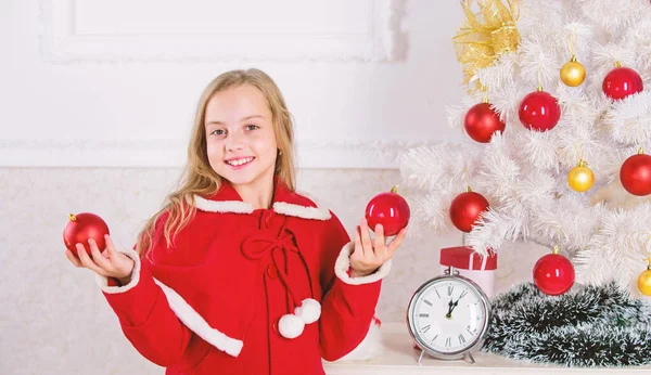 Christmas ball traditional decor. Top christmas decorating ideas for kids room. Kids can brighten up christmas tree by creating their own ornaments. Child red costume hold christmas ornament ball — Stock Photo, Image