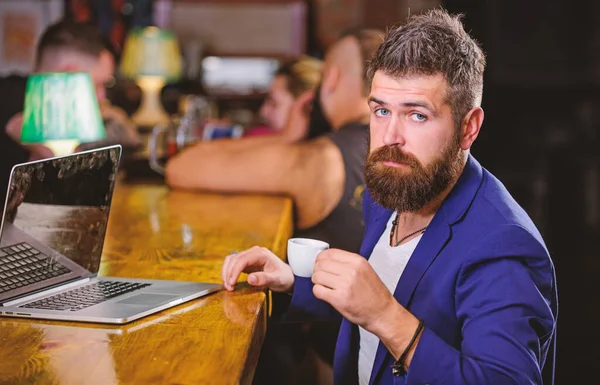 Create content web blog. Manager create post enjoy coffee. Hipster freelancer work online drinking coffee. Man bearded businessman sit bar counter with laptop and cup of coffee. Coffee break concept