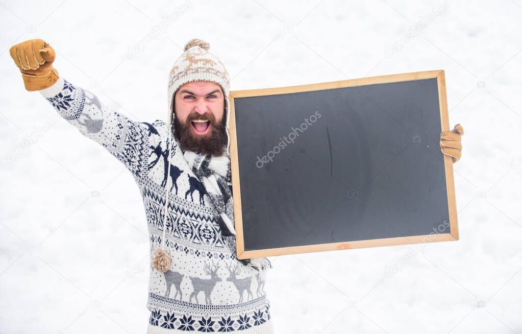 final sales. ski and sledge. happy hipster with blackboard. bearded man in warm clothes. Happy new year. winter holiday. Party here. man advertising board. Copy space. winter season. Christmas sales
