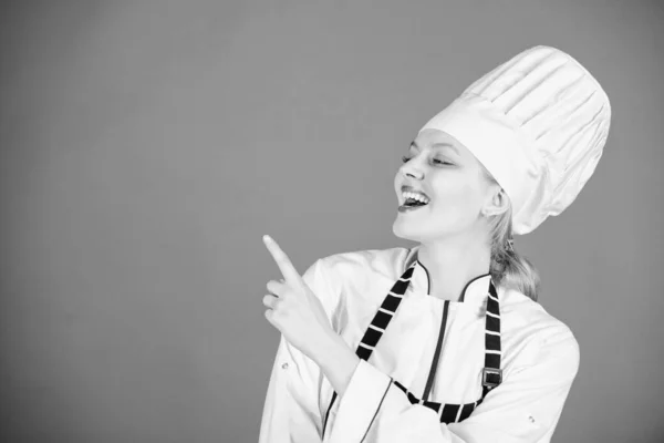 Chef recommend to try something. Confident girl happy chef pointing at copy space. My secret tips culinary. Cooking easy and pleasant occupation. Become chef at restaurant. Special offer from chef