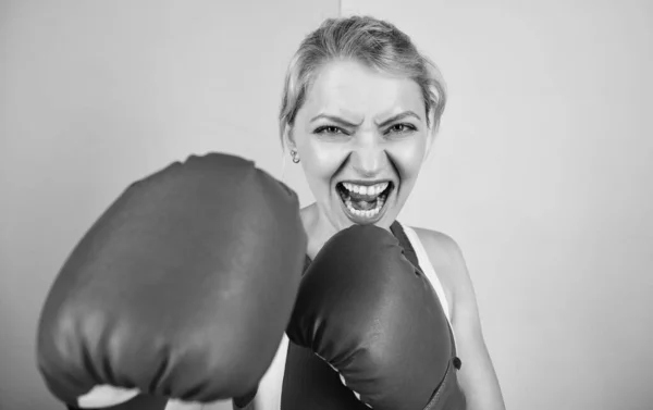 Boxing improve temper and will. Woman boxing gloves focused on attack. Ambitious girl fight boxing gloves. Female rights. I am gonna kick you off. Confident in her boxing skill. Concentrated on punch