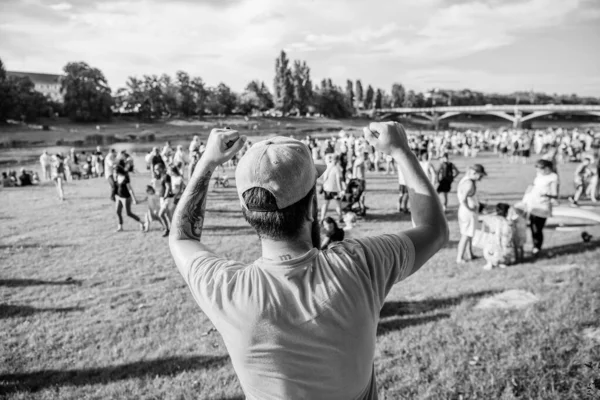 Being happy for someone. Happy fan. Happy hipster making winner gesture on summer landscape. Hipster gesturing with happy emotions in casual wear outdoor