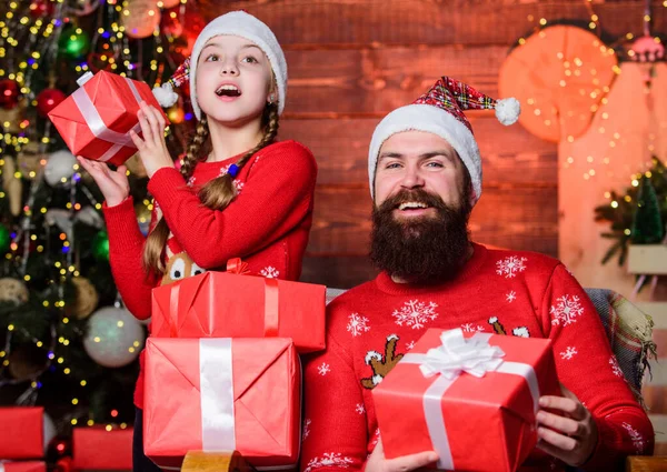 Gifts for nearest. Spend time with your family. Happy holidays. Dad and child opening christmas gifts. Favorite childhood memories of christmas. Father bearded man and daughter near christmas tree
