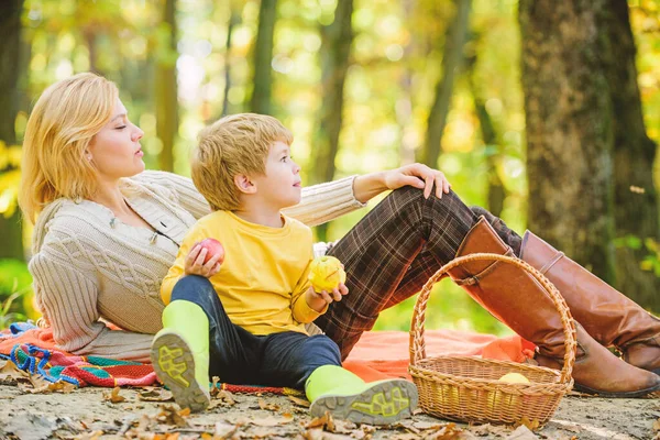 Happy spring day. Spring mood. Happy family day. Sunny weather. Healthy food. Happy son with mother relax in autumn forest. Family picnic. Mothers day. Mother love her small boy child