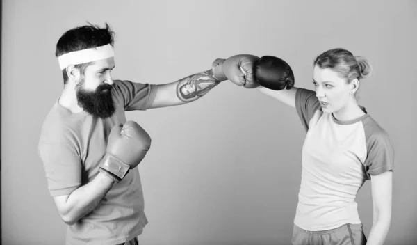 punching, sport Success. knockout and energy. couple training in boxing gloves. Happy woman and bearded man workout in gym. sportswear. Fight. training with coach. Fast and Furious