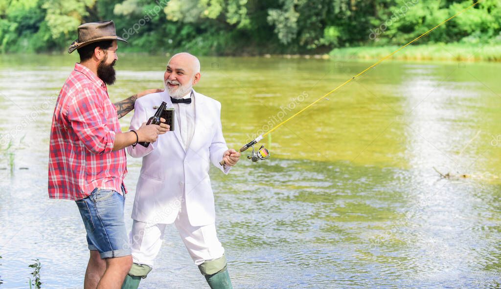 Men relaxing nature background. Fun and relax. Weekend time. Bearded man and elegant businessman fishing together. Fishing skills. Set up rod with hook line and sinker. Fishing and drinking beer