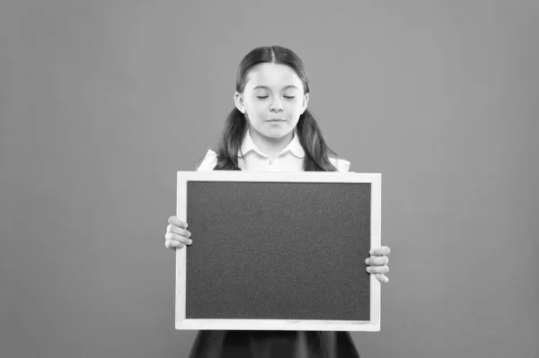 School girl cute pupil hold blackboard copy space. School announcement concept. Informing kids changes in school life. Good news for pupils community. Educational program. School schedule information