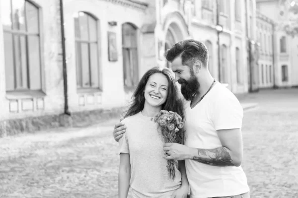 Simple happiness. Romantic date idea. Guy prepared surprise bouquet for girlfriend. True feelings. Bearded hipster fall in love. Couple meeting for date. Man giving flowers. Golden rules perfect date