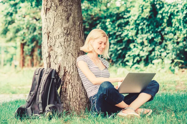 Reasons why you should take your work outside. Lunch time relax or coffee break. Nature is essential to wellbeing and ability to be productive. Work in summer park. Girl work with laptop in park
